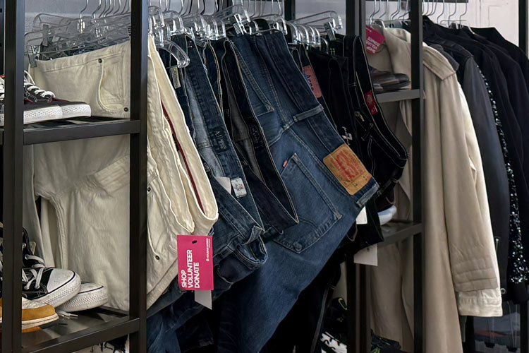 Secondhand mens jeans, pants, and shoes displayed at Housing Works Thrift Shop Brooklyn Heights