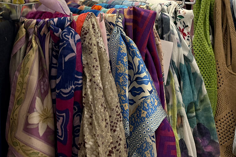 Colorful patterned scarves hanging on a rack at Housing Works Thrift Shop Brooklyn Heights