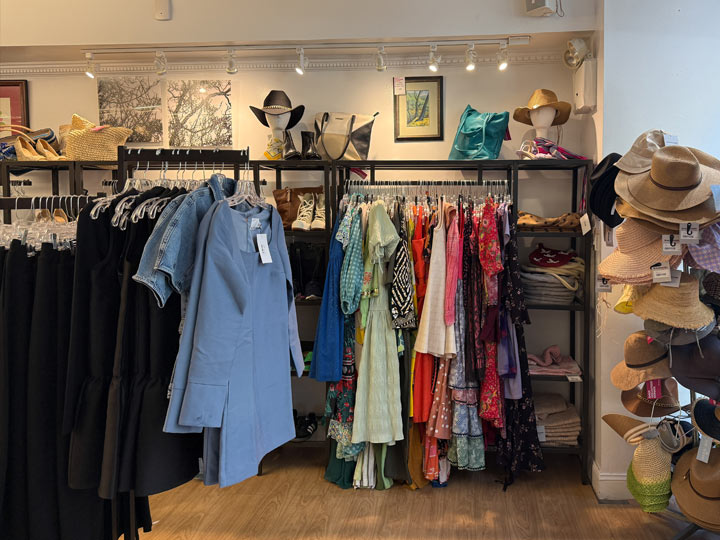 Women’s clothing, handbags, and hats displayed at Housing Works Thrift Shop Brooklyn Heights