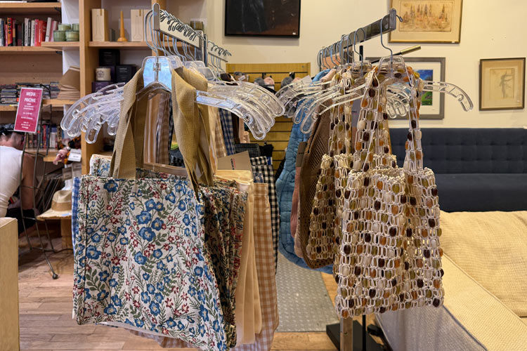 Patterned fabric totes and beaded handbags displayed inside Housing Works Thrift Shop Columbus & 74th Street.