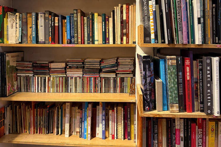 Shelves filled with secondhand books and CDs at Housing Works Thrift Shop West Village.