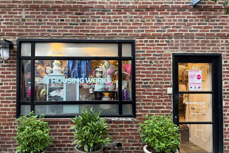 Housing Works Thrift Shop West Village storefront with a brick facade, display window, and entrance.